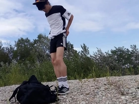 Adidas-clad Jon Arteen, a youthful Asian twink, struts outdoors, flaunting his underwear-free assets. He freeballs, jerks off, and cums in nature, all while maintaining his runner image.