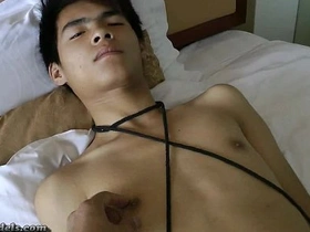 Slim AsianBoyz are in for a wild ride as they indulge in some kinky fun. Bound and gagged, they expertly pleasure a well-endowed partner, creating a tantalizing scene of bondage and desire.