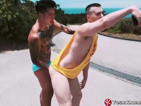 Asian hunk Yoshi Kawasaki and his tattooed partner spice up their outdoor romp with a steamy fist fuck. Yoshi's expertise shines as he skillfully handles Axel's impressive member, culminating in a thrilling, messy finish.