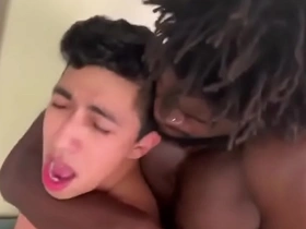 A muscular ebony stud indulges in a passionate encounter with a slender Asian twink, exploring every inch of his body before penetrating his tight, inviting ass, eliciting ecstatic moans.