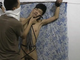 Slim Asian boy, bound and submissive, receives a firm spanking from his master. This BDSM video showcases the young, gay twink's pain and pleasure in a tantalizing display of discipline.