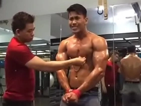 Asian gym rat's nipples are the focus of attention in this steamy gay scene. Witness his sensitive peaks being teased, tugged, and tasted in a tantalizing display of pleasure and submission.