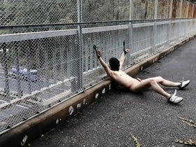 Amateur Japanese duo Takehito and his friend bare it all on a bustling footbridge, pushing the boundaries of exhibitionism. This daring act of nudity and BDSM exploration is a thrilling ride for those who dare to expose.