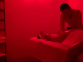 A muscular Asian man offers a sensual massage to a fellow muscular man, their bodies glistening under the soft light. The massage evolves into a passionate encounter, igniting desire and leading to an explosive climax.
