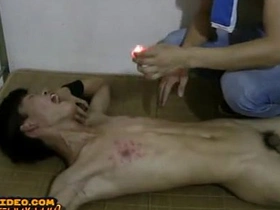 A young, slender Asian lad submits to his master, his smooth skin scorched with hot wax, a painful yet erotic bondage ritual unfolding in this intense BDSM video.