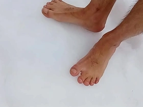 Barefoot in the snow, a tantalizing Asian beauty indulges in her fetish for cold sensations on her delicate feet. Her toes chill in the wintry air, heightening her ecstasy and allure.