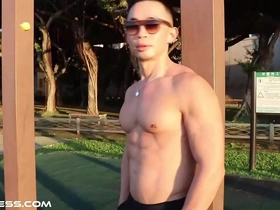 Fit Asian, muscle-bound hunk flaunts his sculpted physique outdoors, flexing his massive pecs, chiseled abs, and bulging biceps. A tantalizing feast for muscle worship enthusiasts.